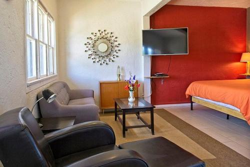 a hotel room with a bedroom with a bed and a tv at Studio 203 in Clarkdale