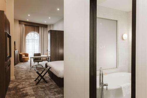 a hotel room with a bed and a bathroom at Doubletree By Hilton Wellington in Wellington