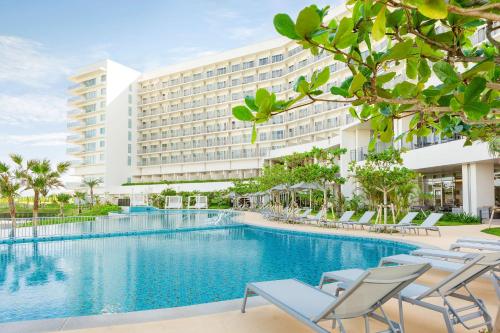 a view of the hotel from the pool at Hilton Club The Beach Resort Sesoko in Motobu