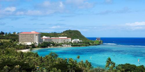a view of a beach with buildings and the ocean at Hilton Guam Resort & Spa in Tumon