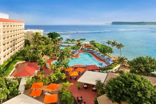 an aerial view of a resort with a pool and the ocean at Hilton Guam Resort & Spa in Tumon