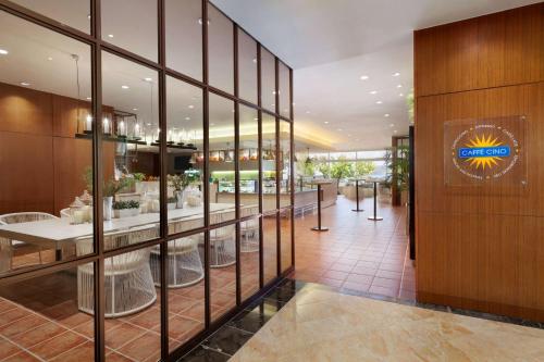 a lobby of a restaurant with a sign on the wall at Hilton Guam Resort & Spa in Tumon