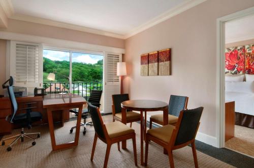 an office with a desk and chairs and a table at Hilton Guam Resort & Spa in Tumon