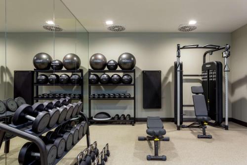 a gym with lots of exercise equipment and weights at Hilton Aberdeen TECA in Aberdeen