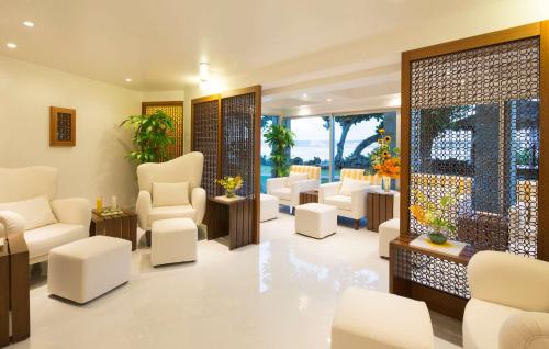 a waiting room with white chairs and tables at Hilton Guam Resort & Spa in Tumon