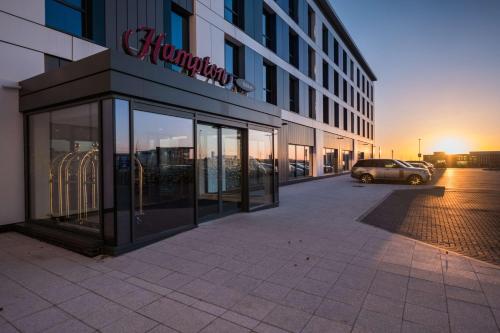 a building with a car parked in front of it at Hampton By Hilton Aberdeen Airport in Dyce