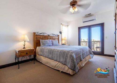 a bedroom with a large bed and a balcony at San Felipe Beach Rental Condo 71-2 in San Felipe