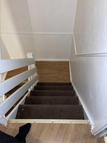 a stairway with a stair case and a stairsuggestuggest at Stunning 2 bedroom green view house in Thamesmead