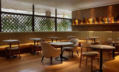 a row of tables and chairs in a restaurant at DoubleTree by Hilton Bath in Bath