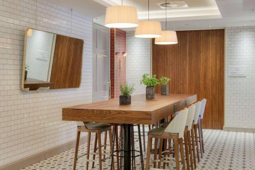a dining room with a wooden table and chairs at DoubleTree by Hilton Bath in Bath