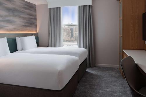 a hotel room with two beds and a window at DoubleTree by Hilton Bath in Bath