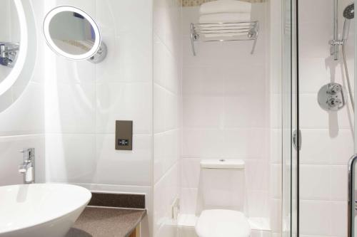 a bathroom with a toilet and a sink and a shower at DoubleTree by Hilton Bath in Bath