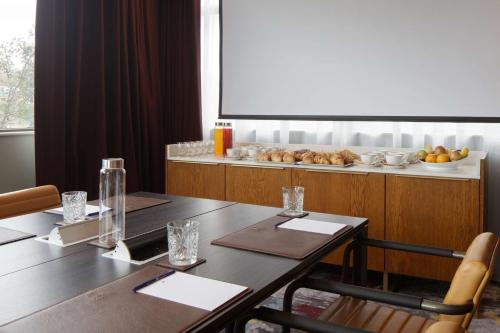 a dining room with a table and a counter with food at DoubleTree by Hilton Bath in Bath