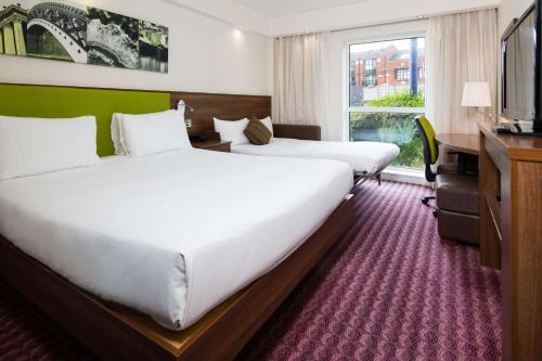 a hotel room with two beds and a television at Hampton by Hilton Birmingham Jewellery Quarter in Birmingham