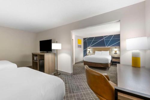 a hotel room with two beds and a flat screen tv at Comfort Inn Hastings in Hastings