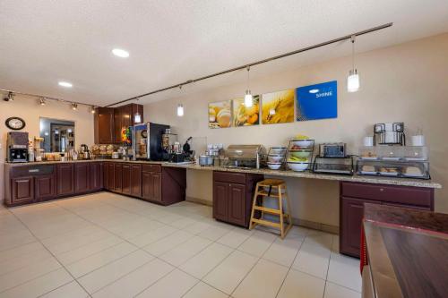 a large kitchen with a counter and a bar at Comfort Inn Hastings in Hastings