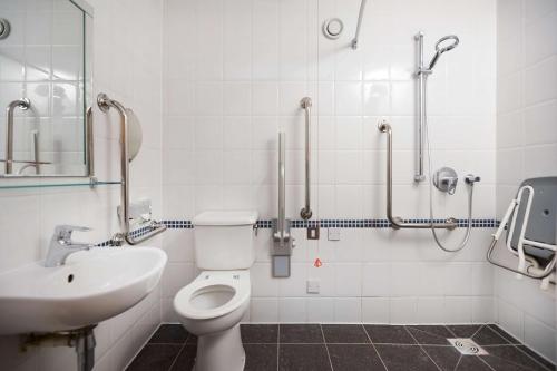 a bathroom with a toilet and a sink at DoubleTree by Hilton Coventry in Coventry