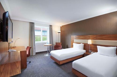 a hotel room with two beds and a television at DoubleTree by Hilton Bristol North in Bristol
