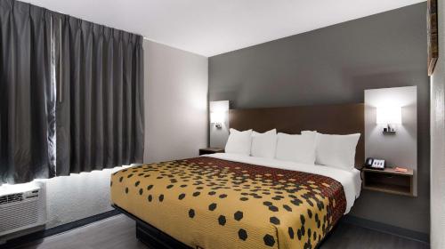 a hotel room with a bed and a large window at Econo Lodge Portage in Portage