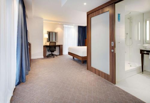a hotel room with a bed and a bathroom at Hampton by Hilton Dundee City Centre in Dundee