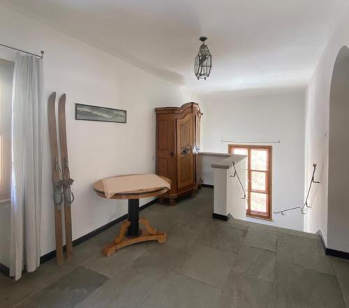 a room with a table and a desk and a chair at Villa Bochert in Zuoz