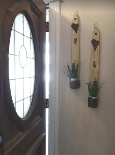 a door with a window and two plants on the wall at Prime location! 4 bedroom house located right next to the casino and the falls in Niagara Falls
