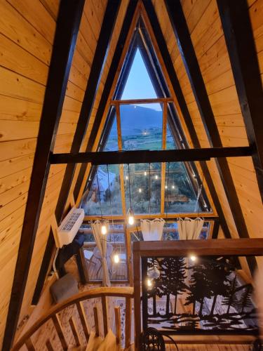 a view from the loft of a tree house with a large window at Eka's Village in Plav