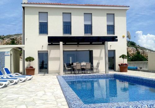 a house with a swimming pool in front of a house at Luxury Villa Lule with private pool near Dubrovnik in Ivanica