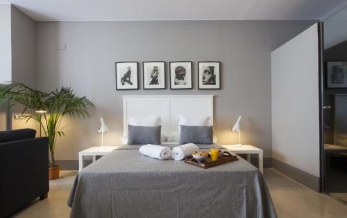 a bedroom with a bed with two pillows on it at Kare No Apartments by Sitges Group in Sitges