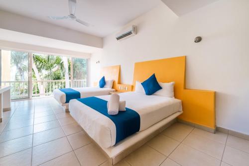 Postel nebo postele na pokoji v ubytování Hotel Ixzi Plus