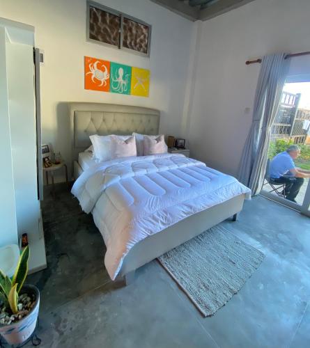 a bedroom with a large bed and a window at Casa Playa Puerto luz in Santa Marta