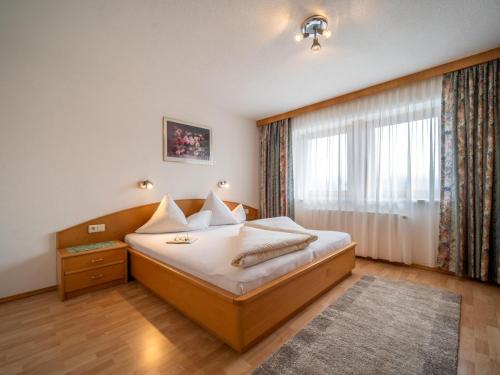 a hotel room with a bed and a window at Apartment Rohrmoser in Laimach