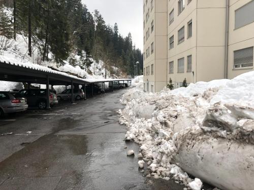 a pile of snow on the side of a street at Laax with indoor and outside pool, sauna, 200 Meter to Ski lift , Fitnessroom, Tennis Place, Joyroom, Parkstadion Reserve in Laax