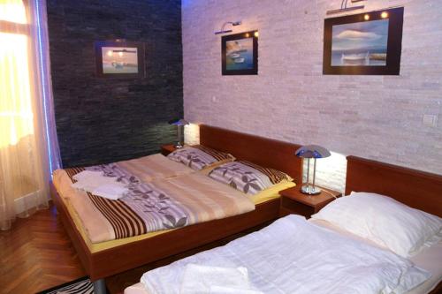 a bedroom with two beds in a room at Apartments and rooms by the sea Nin, Zadar - 5858 in Nin