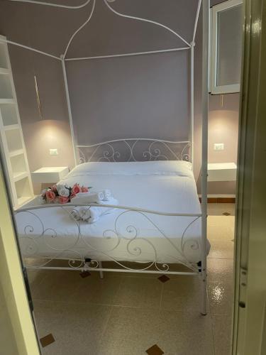 a white bed with a canopy in a room at Dimora Agnese in Casalabate