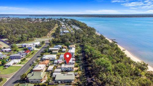 an aerial view of a beach with houses at OceanViews on Burrum Whole in Burrum Heads