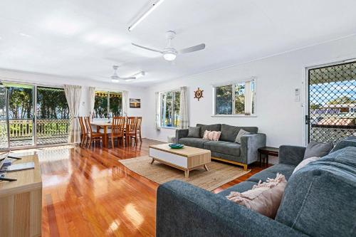 a living room with a couch and a table at OceanViews on Burrum Whole in Burrum Heads