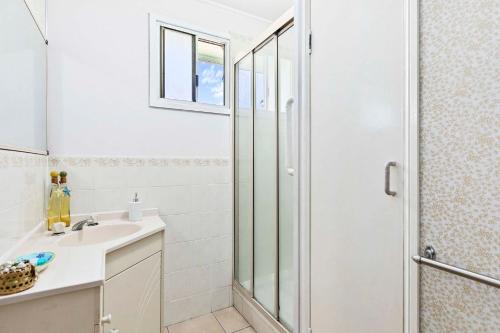 a bathroom with a shower and a sink at OceanViews on Burrum Whole in Burrum Heads