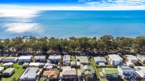 an aerial view of a row of houses next to the ocean at OceanViews on Burrum Whole in Burrum Heads