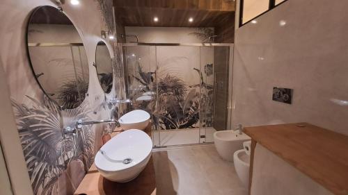 a bathroom with a sink and two toilets and a shower at CAIETA Housing in Gaeta