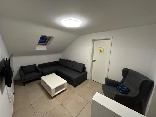 a living room with a couch and two chairs at Best Cologne in Cologne