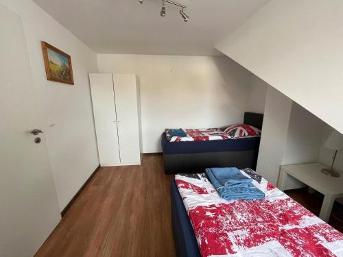 a small room with two beds and a table at Best Cologne in Cologne