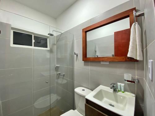 a bathroom with a toilet and a sink and a mirror at Hotel La Casablanca Tayrona in Calabazo