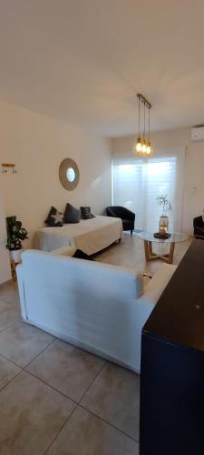 ein Wohnzimmer mit 2 Betten und einem Sofa in der Unterkunft Duplex cómodo y elegante zona alta de Mendoza in El Challao