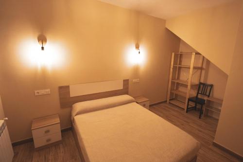 a small bedroom with a bed and a chair at CASA RURAL EL PADRONCILLO in Riópar