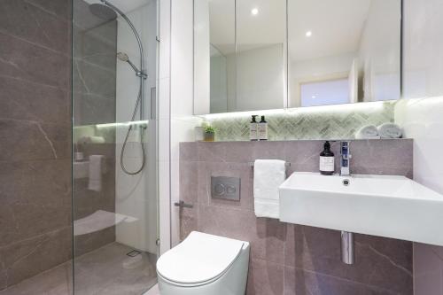 a bathroom with a sink and a toilet and a shower at Urban Retreat in Surry Hills l 2 Bedroom Property with Parking in Sydney