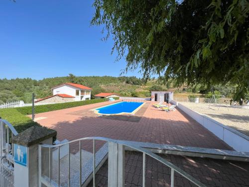 a house with a swimming pool in a yard at Quinta das Covas - Trancoso in Trancoso