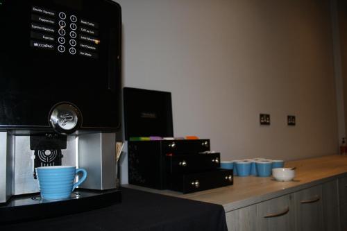 a counter with a coffee maker and a cup on it at Holiday Inn Telford Ironbridge by IHG in Telford