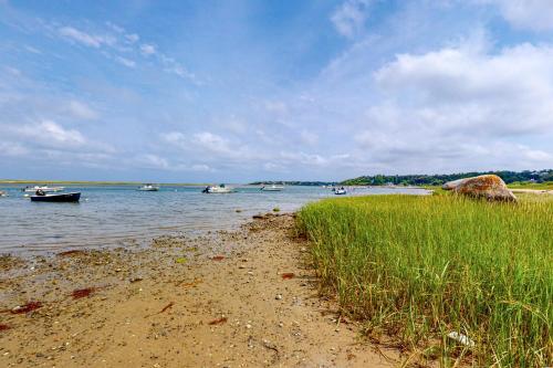 a beach with boats in a body of water at Gray Gables in Orleans