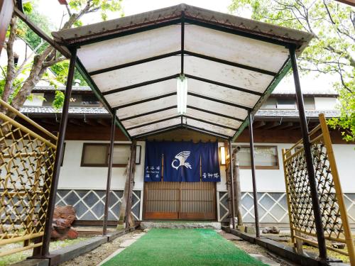 an entrance to a house with a blue and white door at Wakamiro in Hokuto
